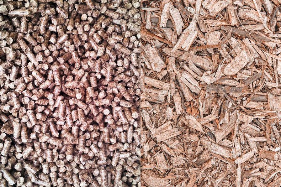 Foto som viser forskellen på træpiller og træflis. Begge dele bliver brugt til at lave grøn fjernvarme.